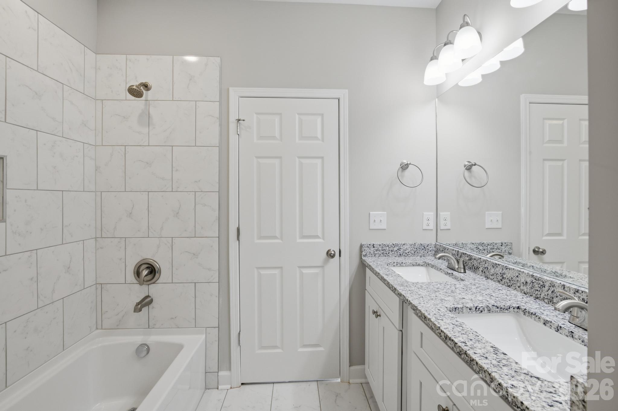 368 Lippard Farm Road Statesville, NC 28625 - Photo 4 of 29 a bathroom with a granite countertop bathtub a sink and a mirror