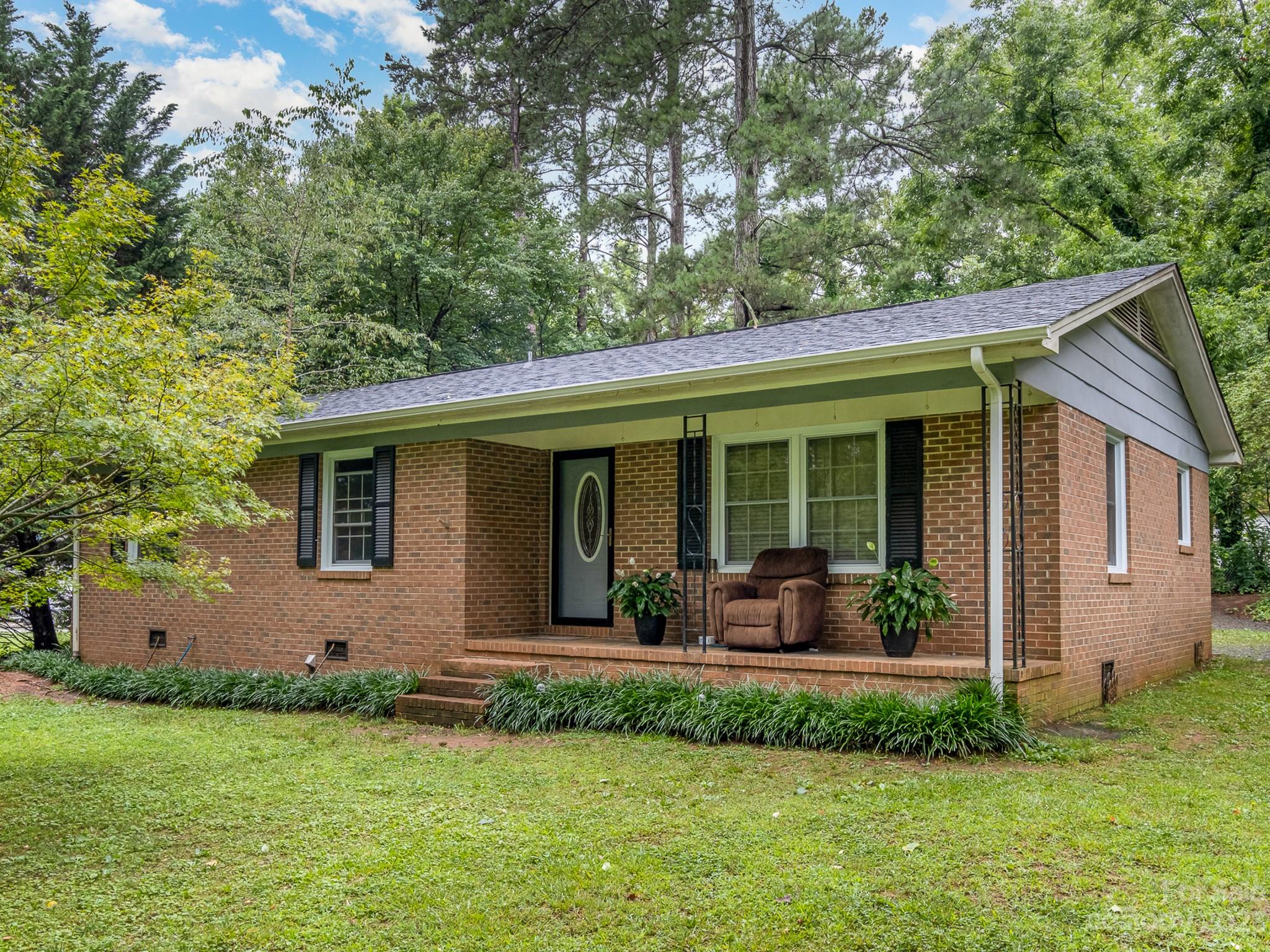 a front view of house with yard and green space