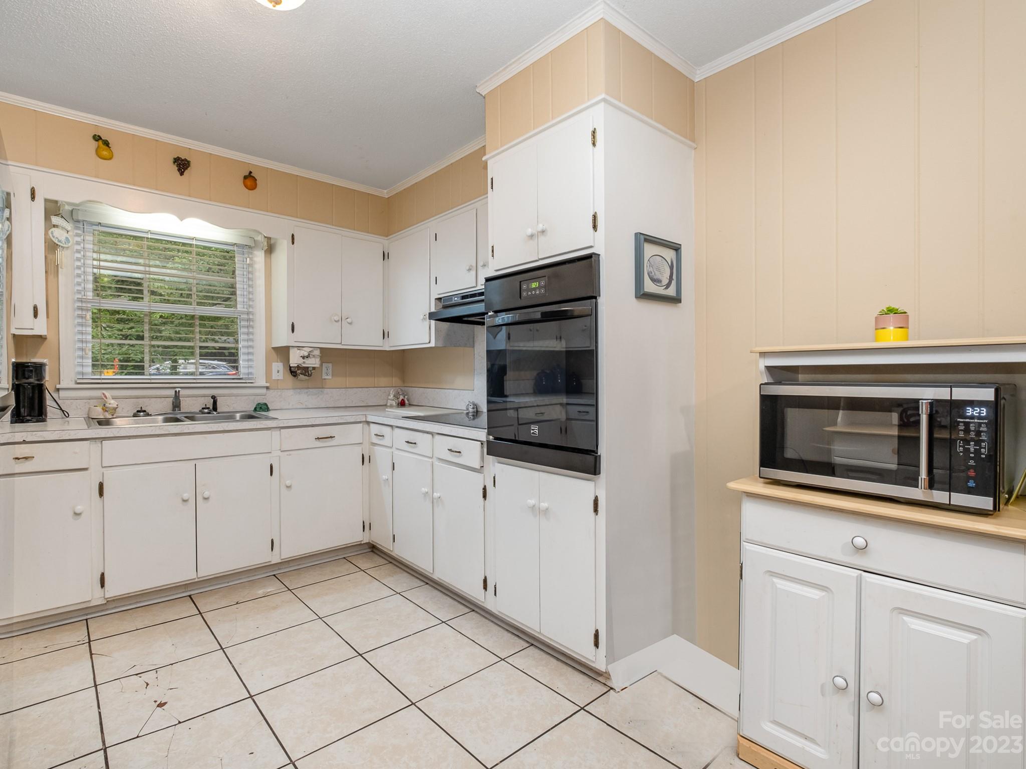648 Blacksnake Road Stanley, NC 28164 - Photo 12 of 24 a kitchen with granite countertop cabinets stainless steel appliances and a window