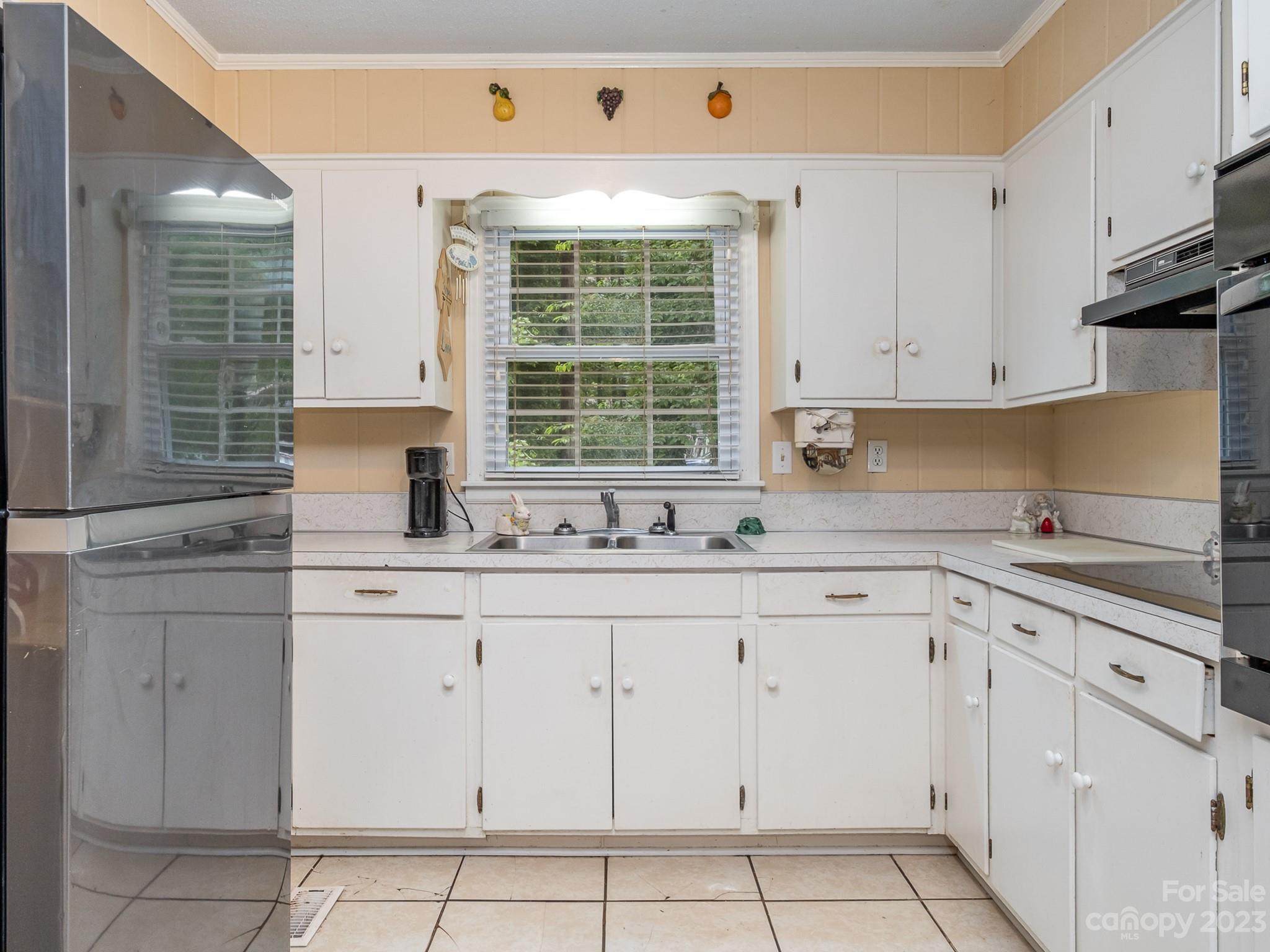 648 Blacksnake Road Stanley, NC 28164 - Photo 13 of 24 a kitchen with white cabinets and window