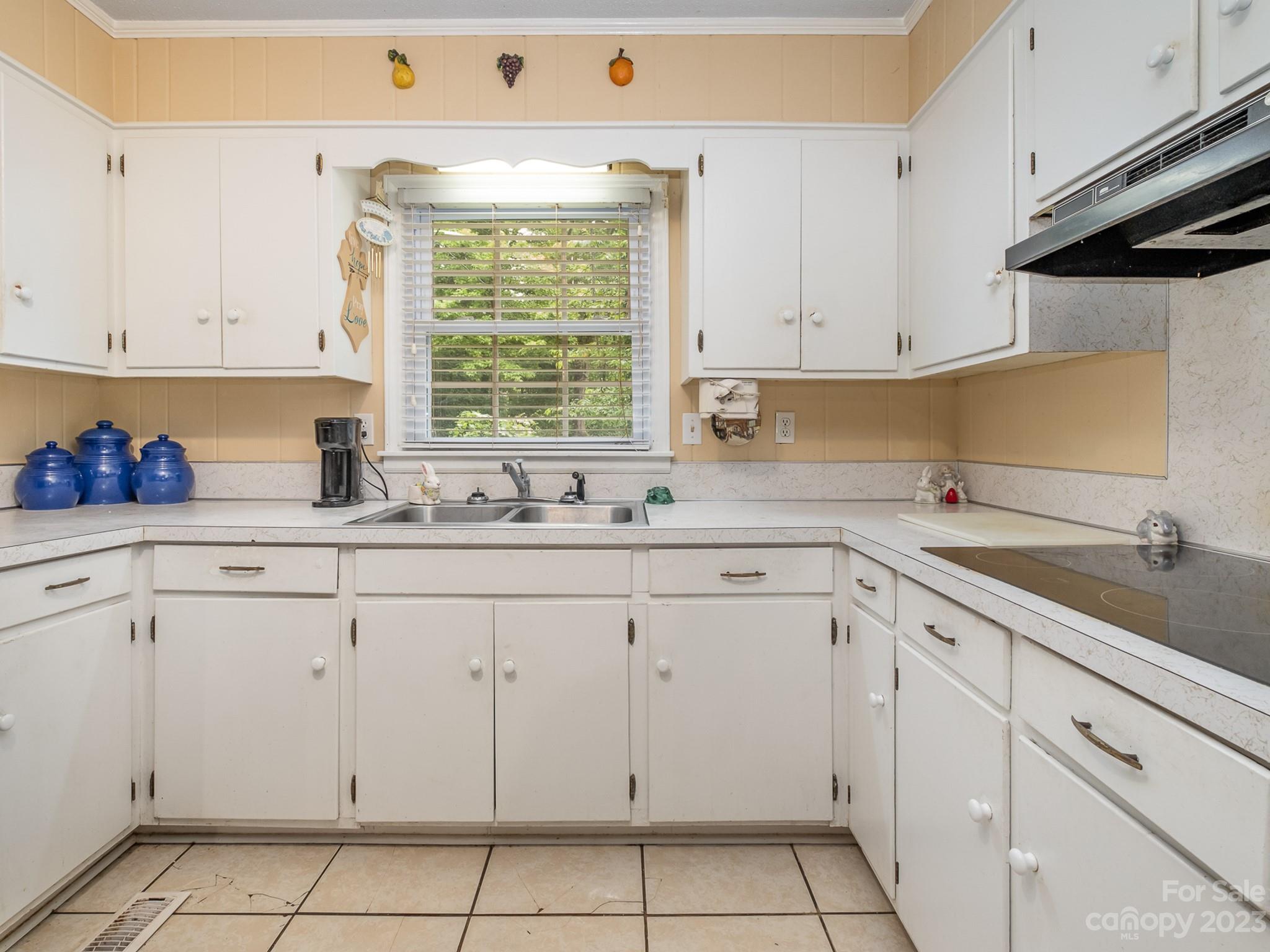 648 Blacksnake Road Stanley, NC 28164 - Photo 14 of 24 a kitchen with white cabinets and white appliances
