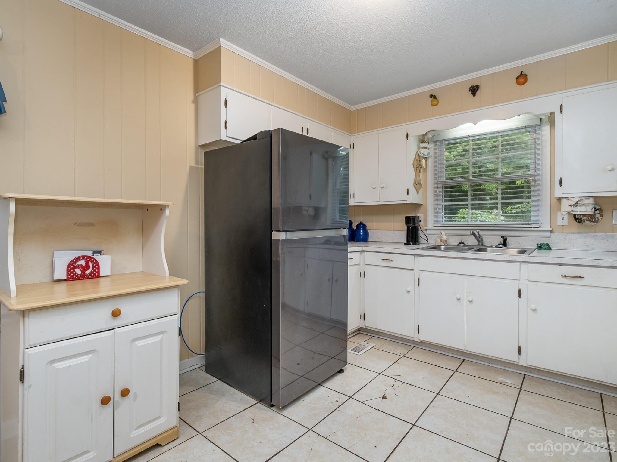 648 Blacksnake Road Stanley, NC 28164 - Photo 15 of 24 a kitchen with white cabinets and refrigerator