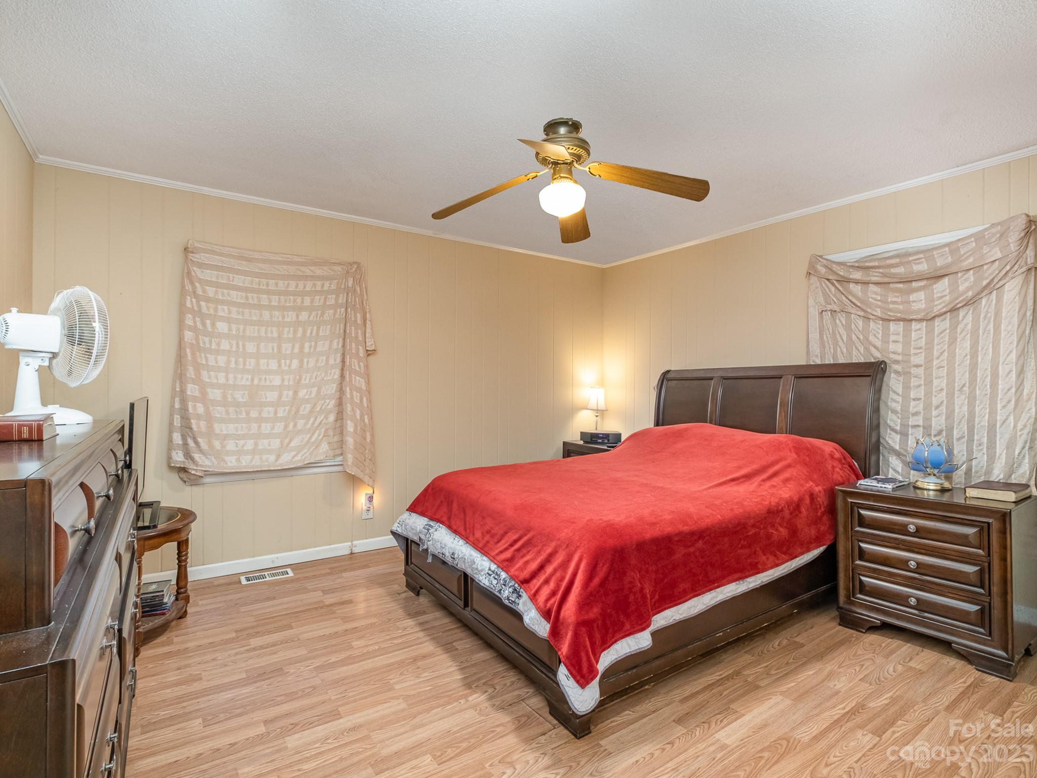 648 Blacksnake Road Stanley, NC 28164 - Photo 16 of 24 a bedroom with a bed and a chandelier