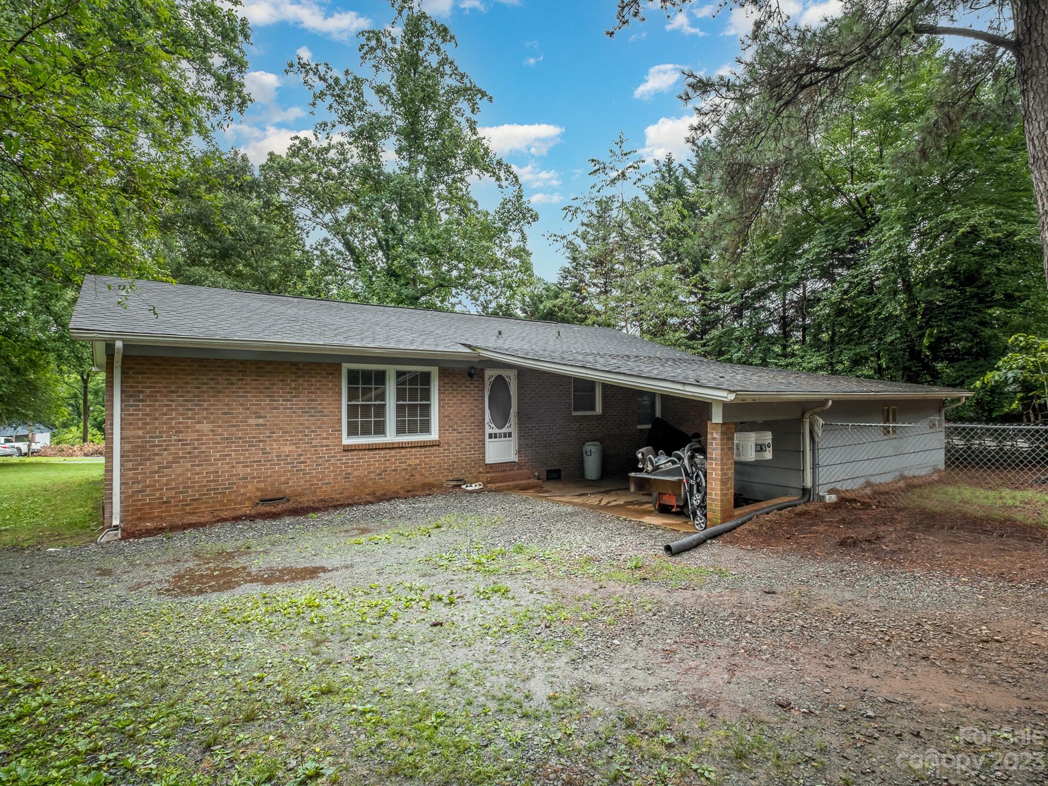 648 Blacksnake Road Stanley, NC 28164 - Photo 22 of 24 a view of a house with a backyard and chairs