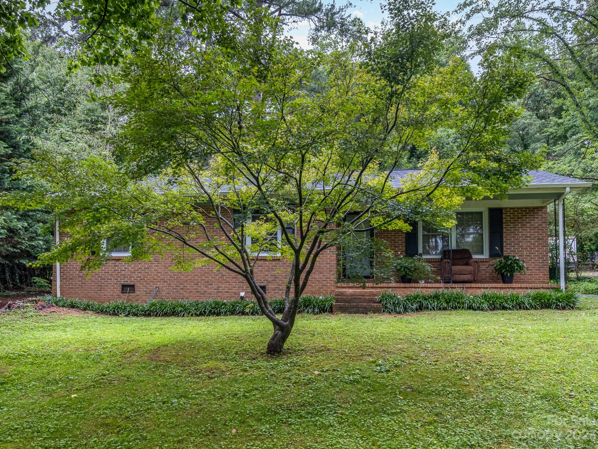 648 Blacksnake Road Stanley, NC 28164 - Photo 4 of 24 a view of a house with a yard and sitting area