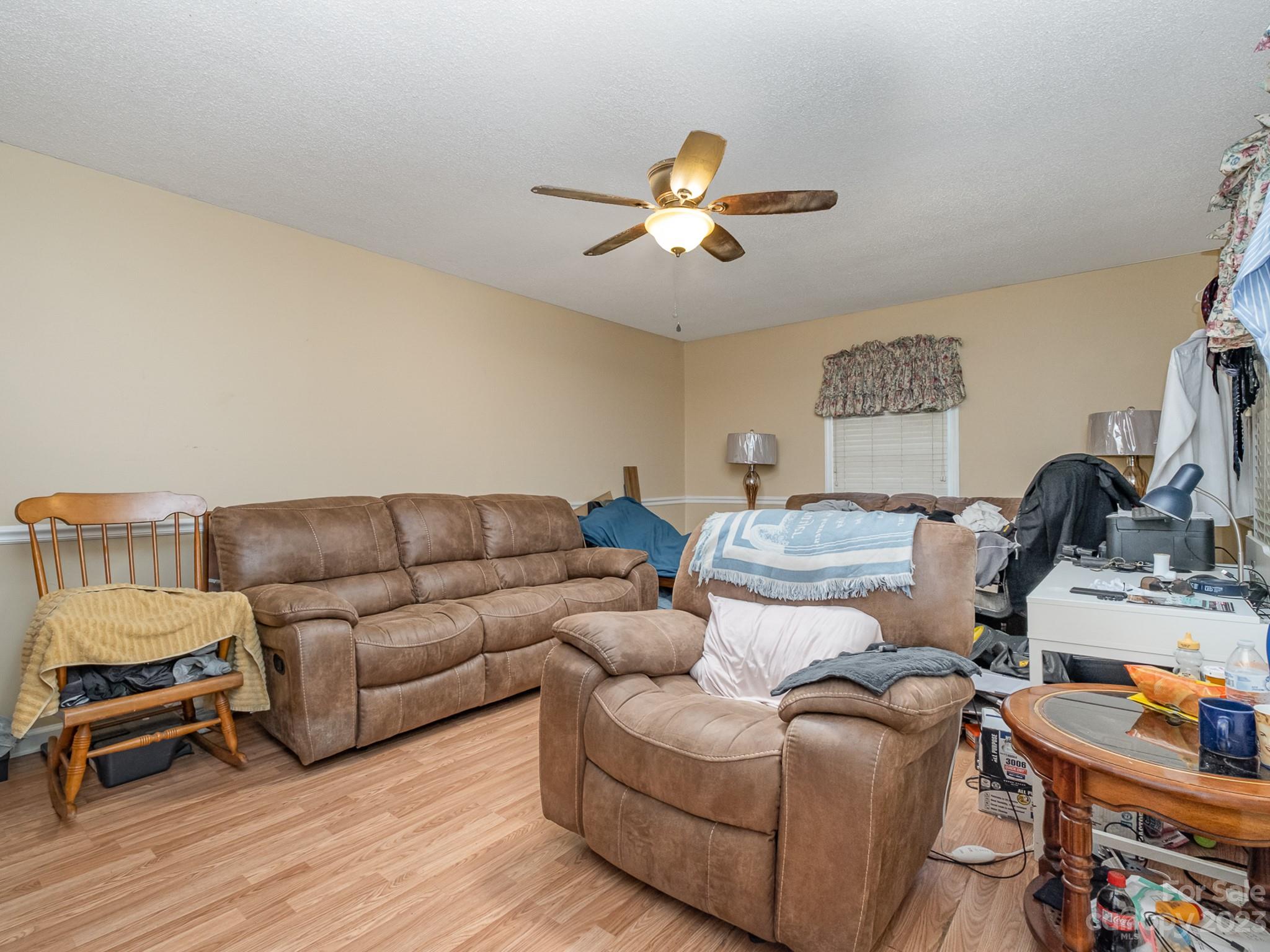 648 Blacksnake Road Stanley, NC 28164 - Photo 7 of 24 a living room with furniture and a flat screen tv
