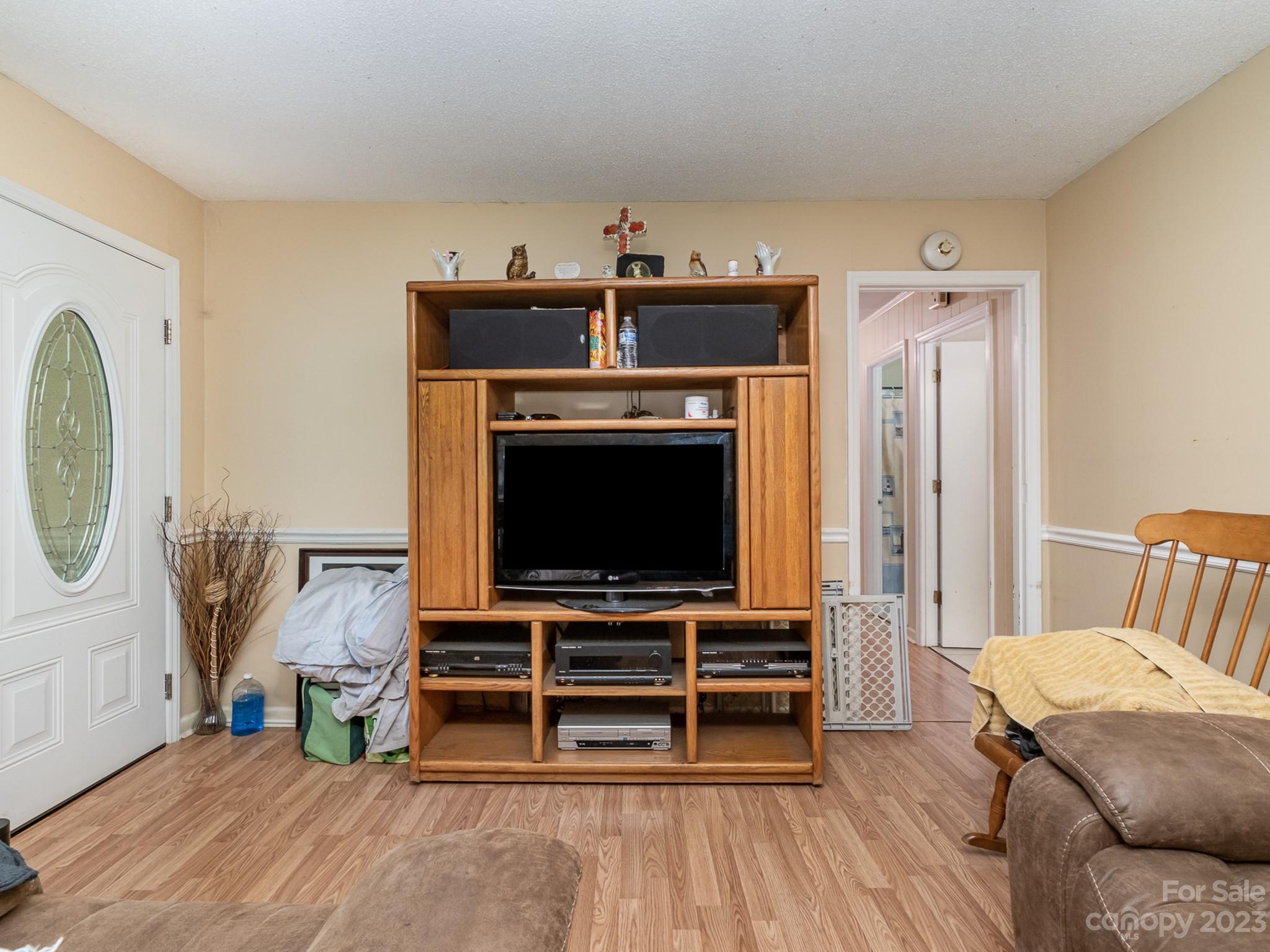 648 Blacksnake Road Stanley, NC 28164 - Photo 8 of 24 a living room with furniture and a flat screen tv