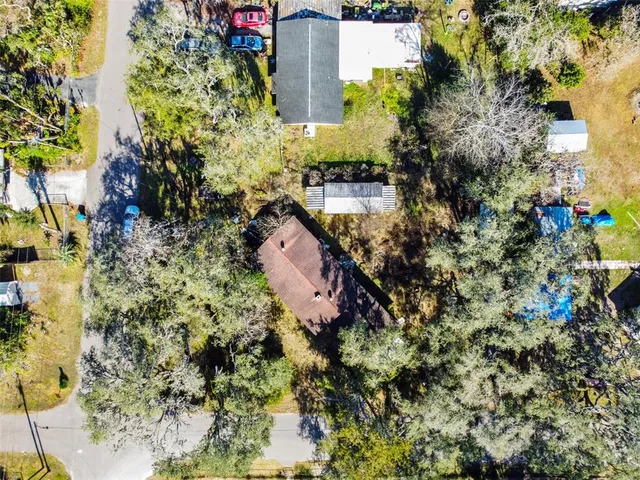 an aerial view of a houses with a yard