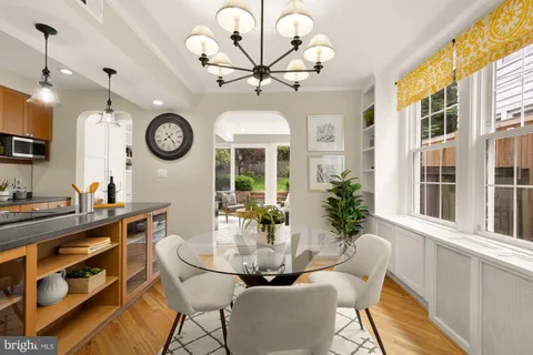 a kitchen with kitchen island granite countertop a stove a sink and a cabinets