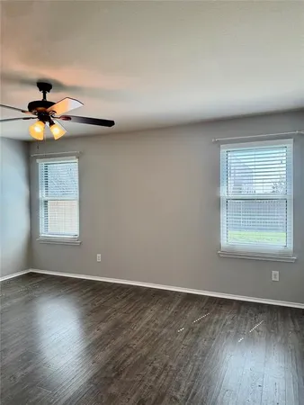 a view of a room with wooden floor