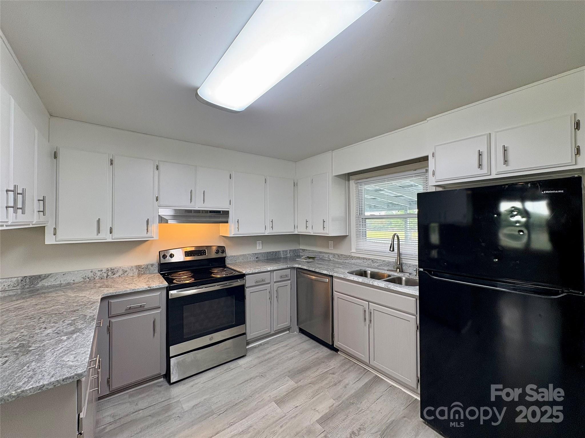 3123 Stack Road Monroe, NC 28112 - Photo 14 of 28 a kitchen with granite countertop stainless steel appliances and wooden cabinets