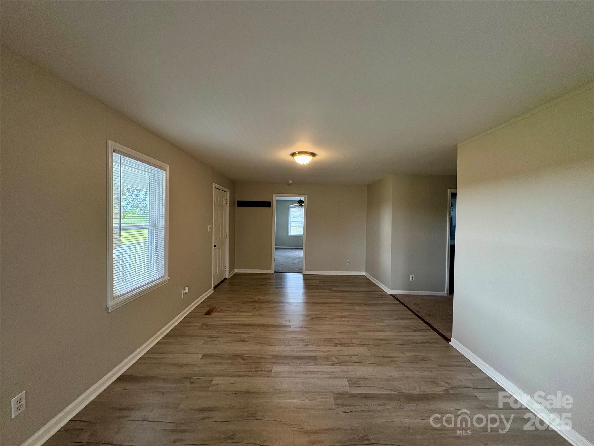 3123 Stack Road Monroe, NC 28112 - Photo 16 of 28 an empty room with wooden floor and windows