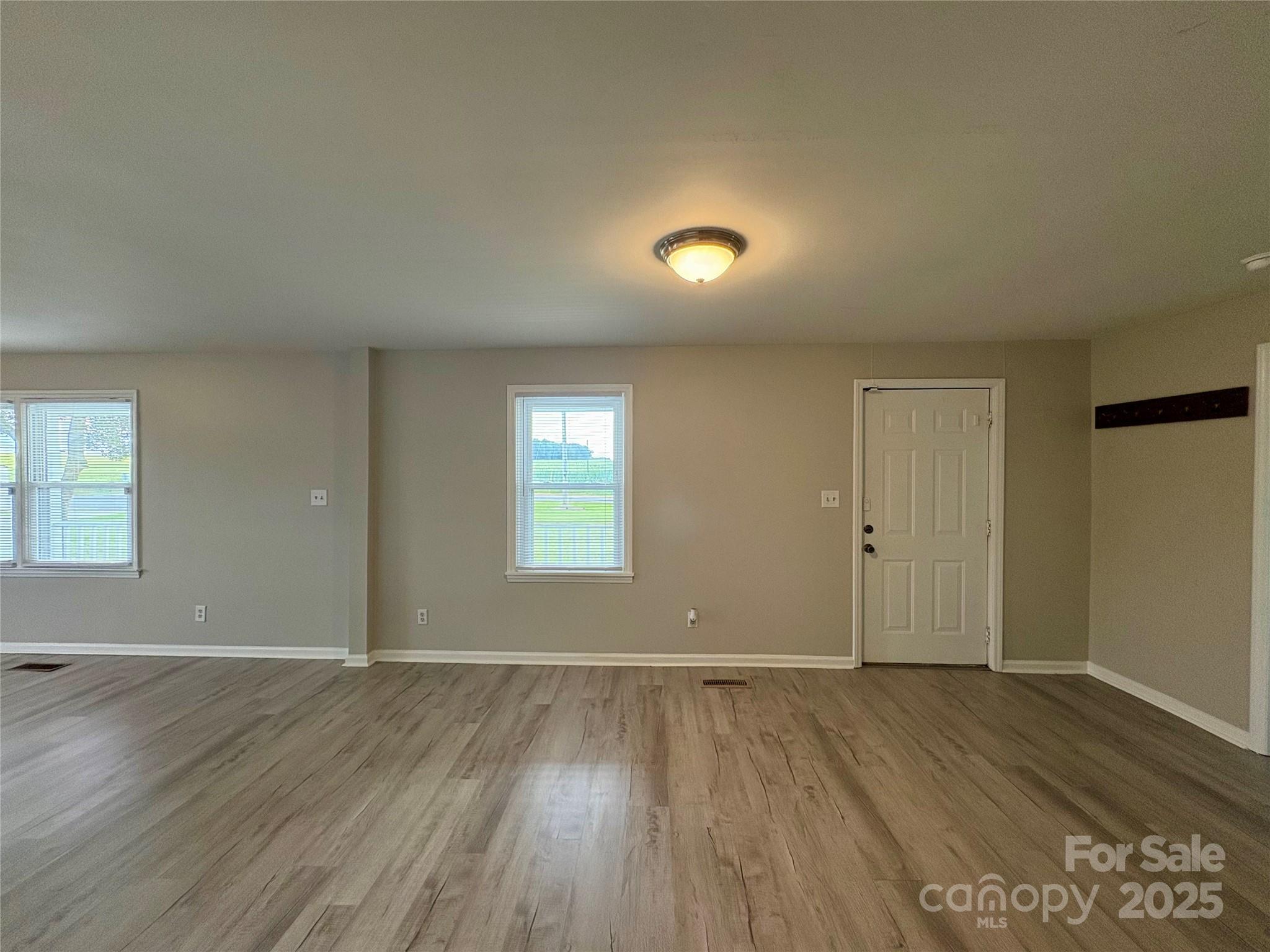 3123 Stack Road Monroe, NC 28112 - Photo 17 of 28 an empty room with wooden floor and windows
