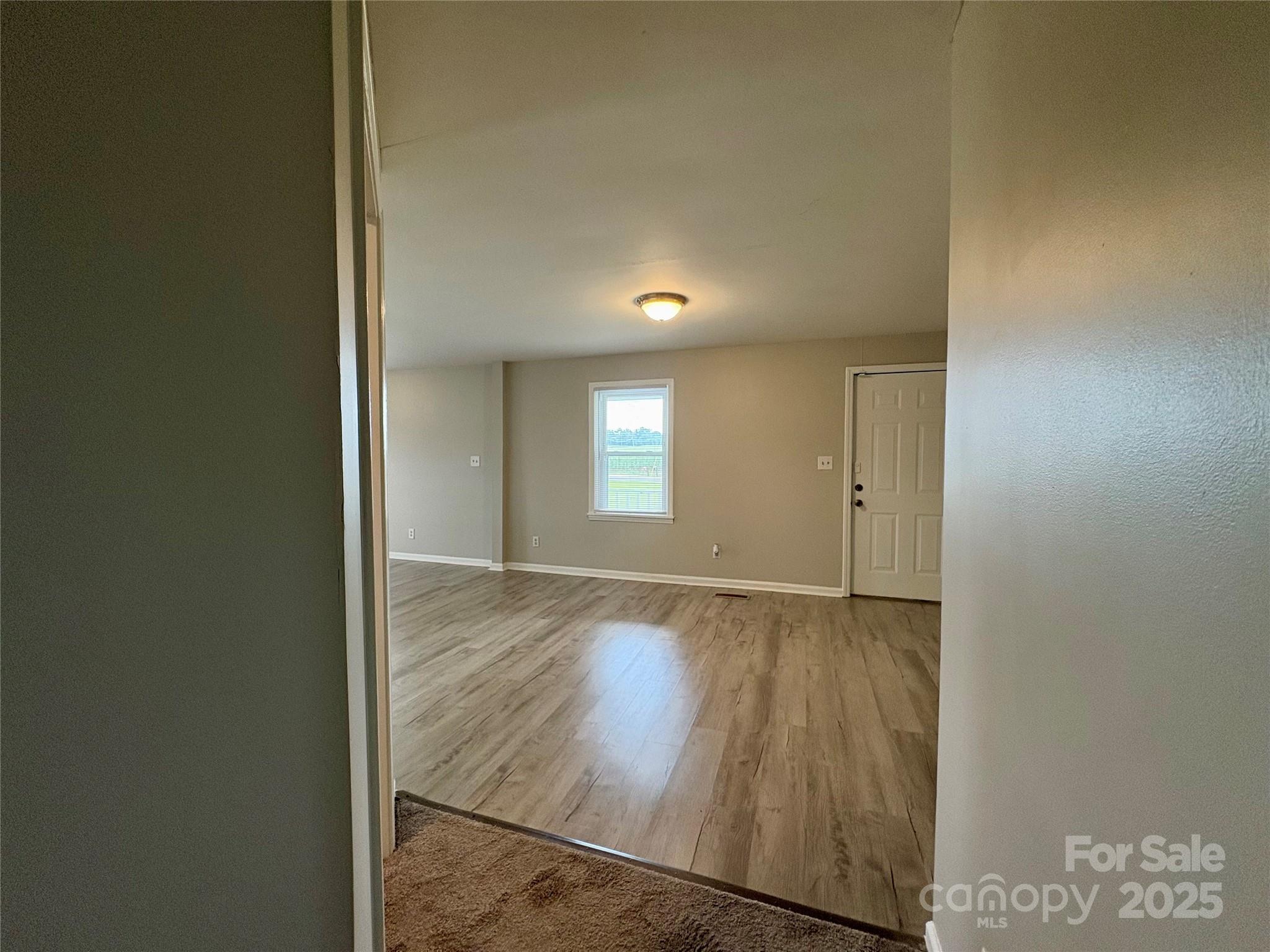 3123 Stack Road Monroe, NC 28112 - Photo 23 of 28 an empty room with wooden floor and windows