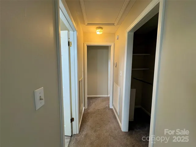 a view of a hallway with wooden shelves