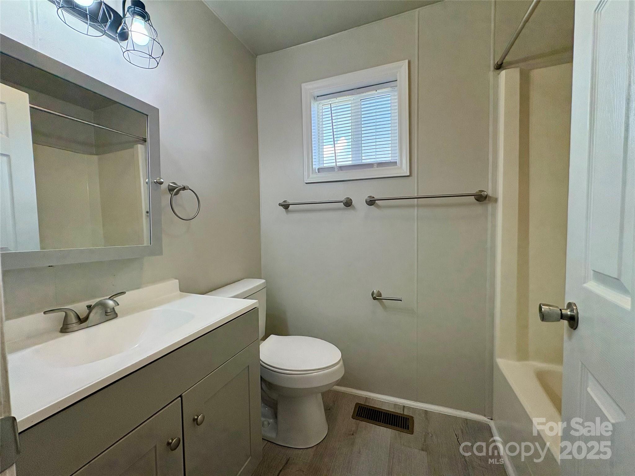 3123 Stack Road Monroe, NC 28112 - Photo 26 of 28 a bathroom with a sink a toilet and a mirror