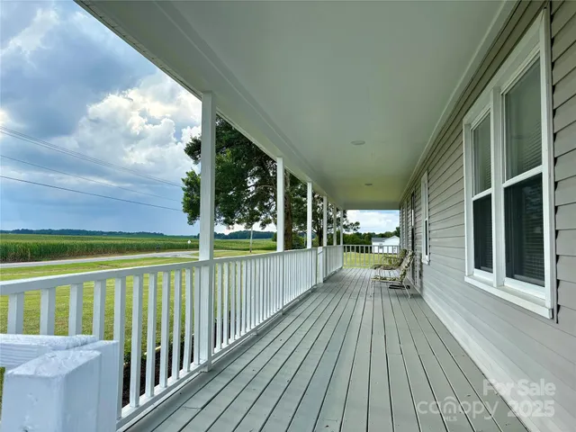 a view of a balcony with wooden floor