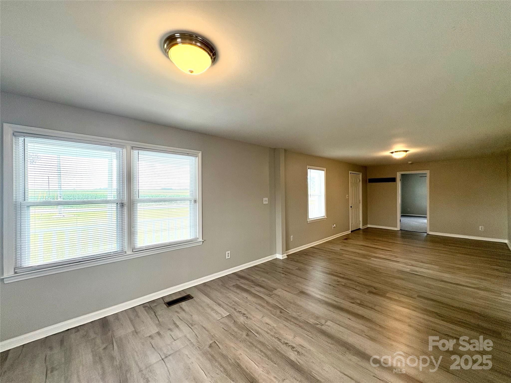 3123 Stack Road Monroe, NC 28112 - Photo 9 of 28 an empty room with wooden floor and windows