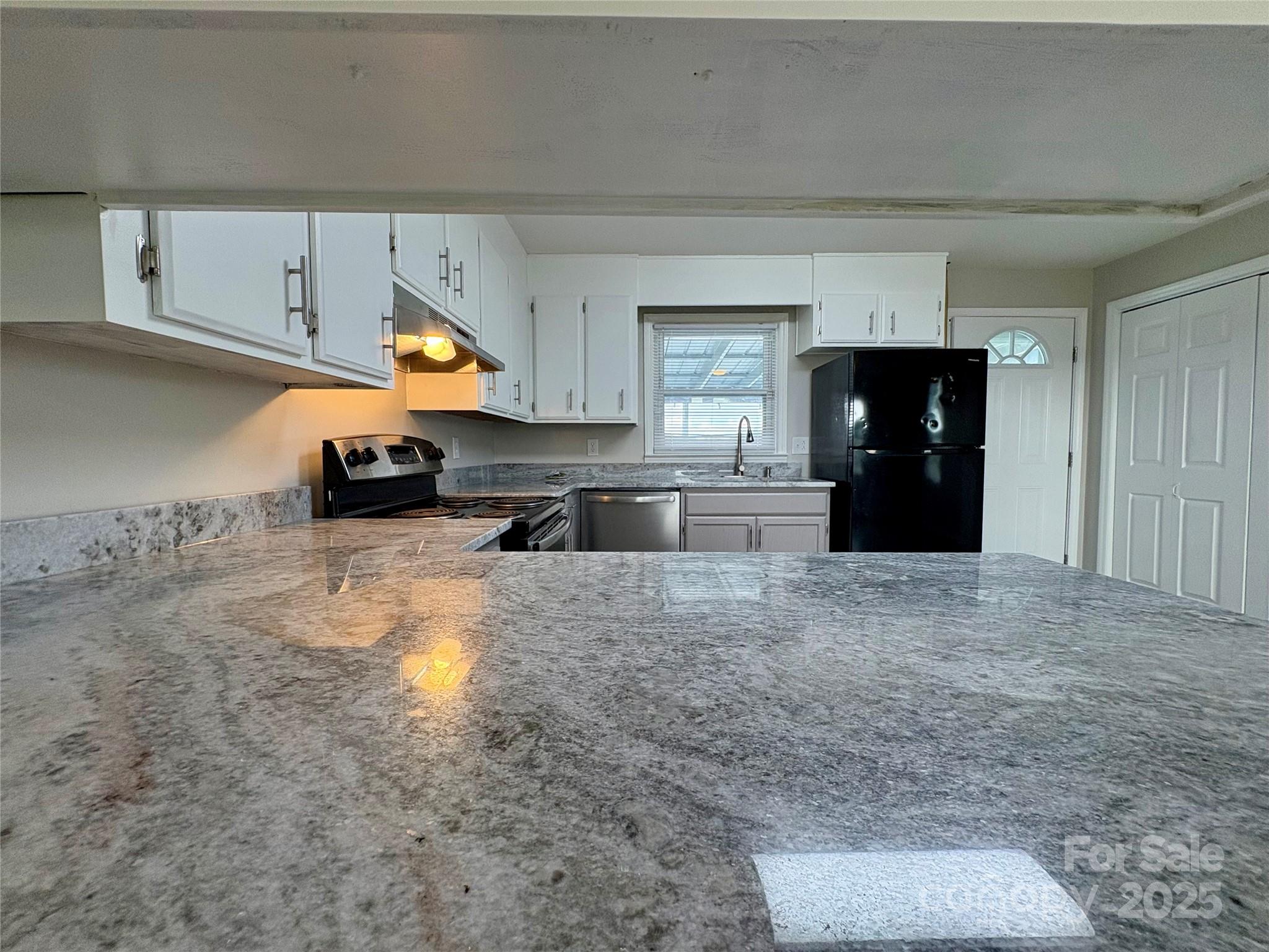 3123 Stack Road Monroe, NC 28112 - Photo 10 of 28 a kitchen with stainless steel appliances a refrigerator a stove and a sink