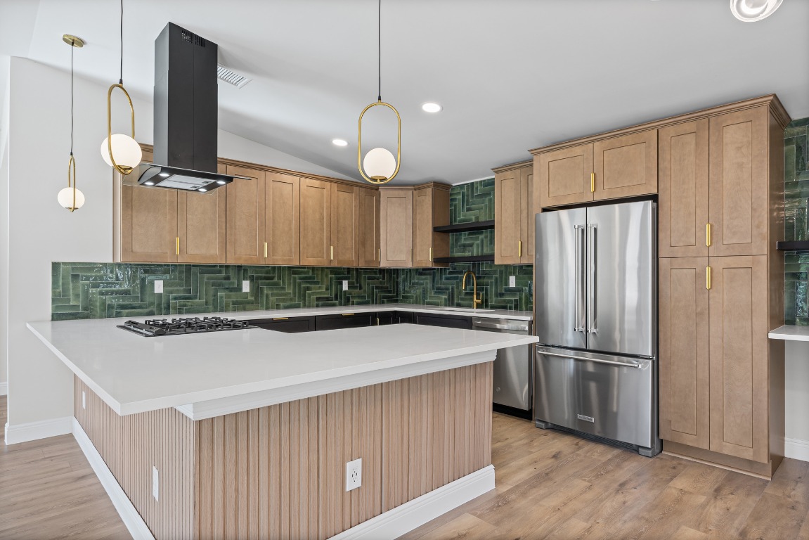 1712 Hillcrest Lane Austin, TX 78721 - Photo 6 of 25 a kitchen with stainless steel appliances a refrigerator and wooden floor