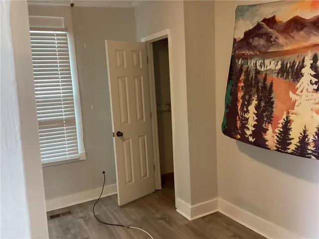 an entryway with a window and wooden floor