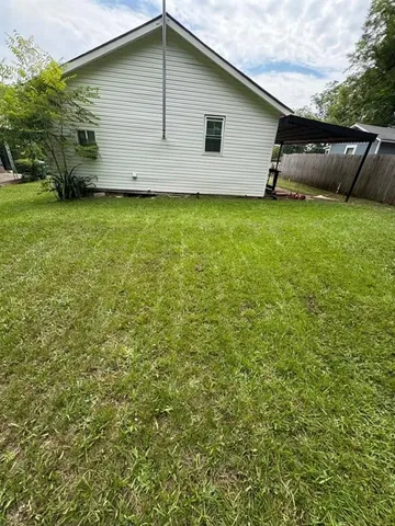 a backyard of a house with lots of green space