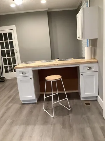 a white cabinet sitting in a kitchen next to a window