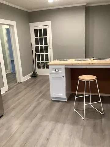 a room with washing machine and cabinets