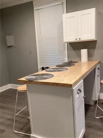 a utility room with granite countertop a sink and a stove