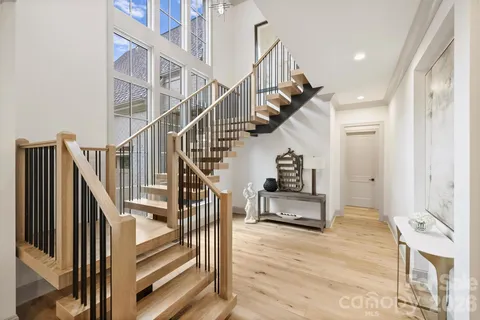 a view of entryway and hall with wooden floor