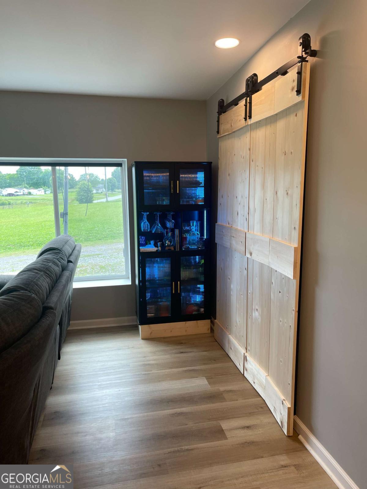 433 Spring Place Resaca Road Chatsworth, GA 30705 - Photo 13 of 60 a room with furniture and a floor to ceiling window