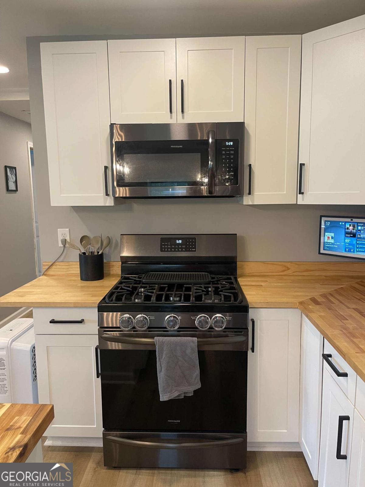 433 Spring Place Resaca Road Chatsworth, GA 30705 - Photo 17 of 60 a kitchen with stainless steel appliances granite countertop a stove a microwave and oven
