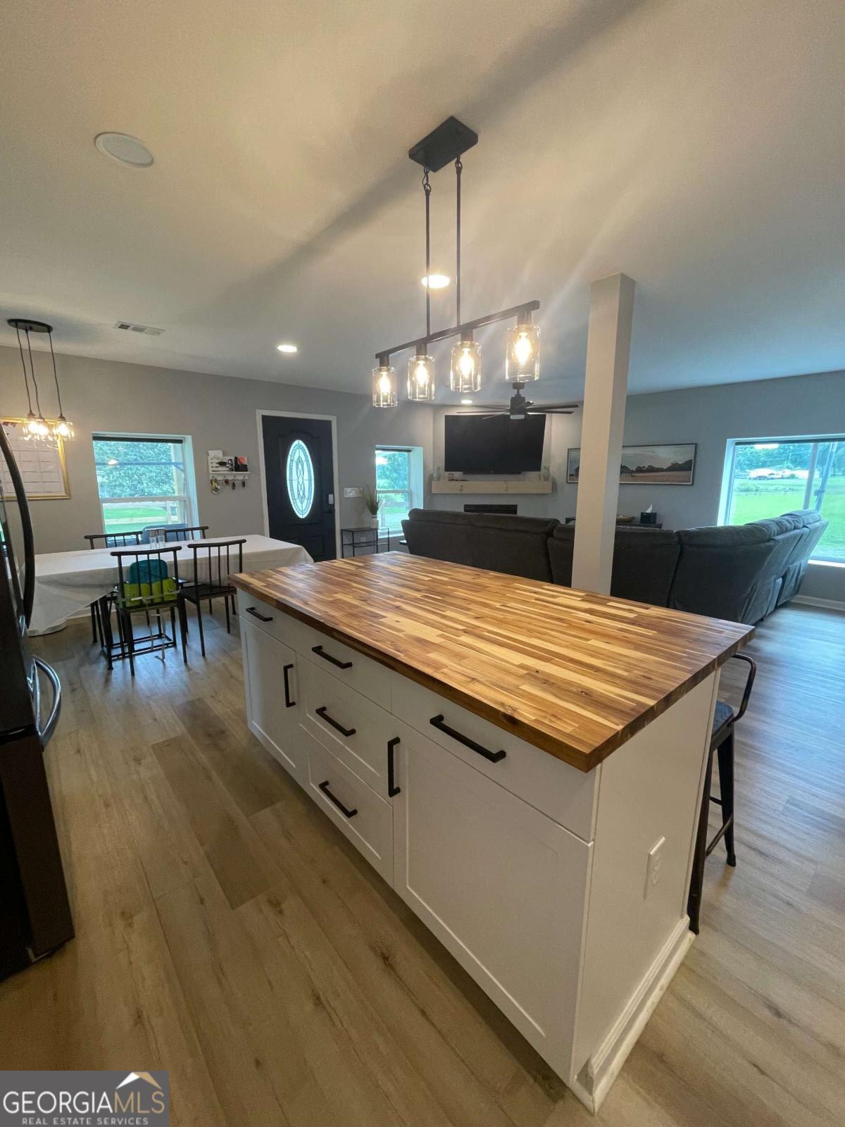 433 Spring Place Resaca Road Chatsworth, GA 30705 - Photo 18 of 60 a large kitchen with kitchen island a sink table and chairs