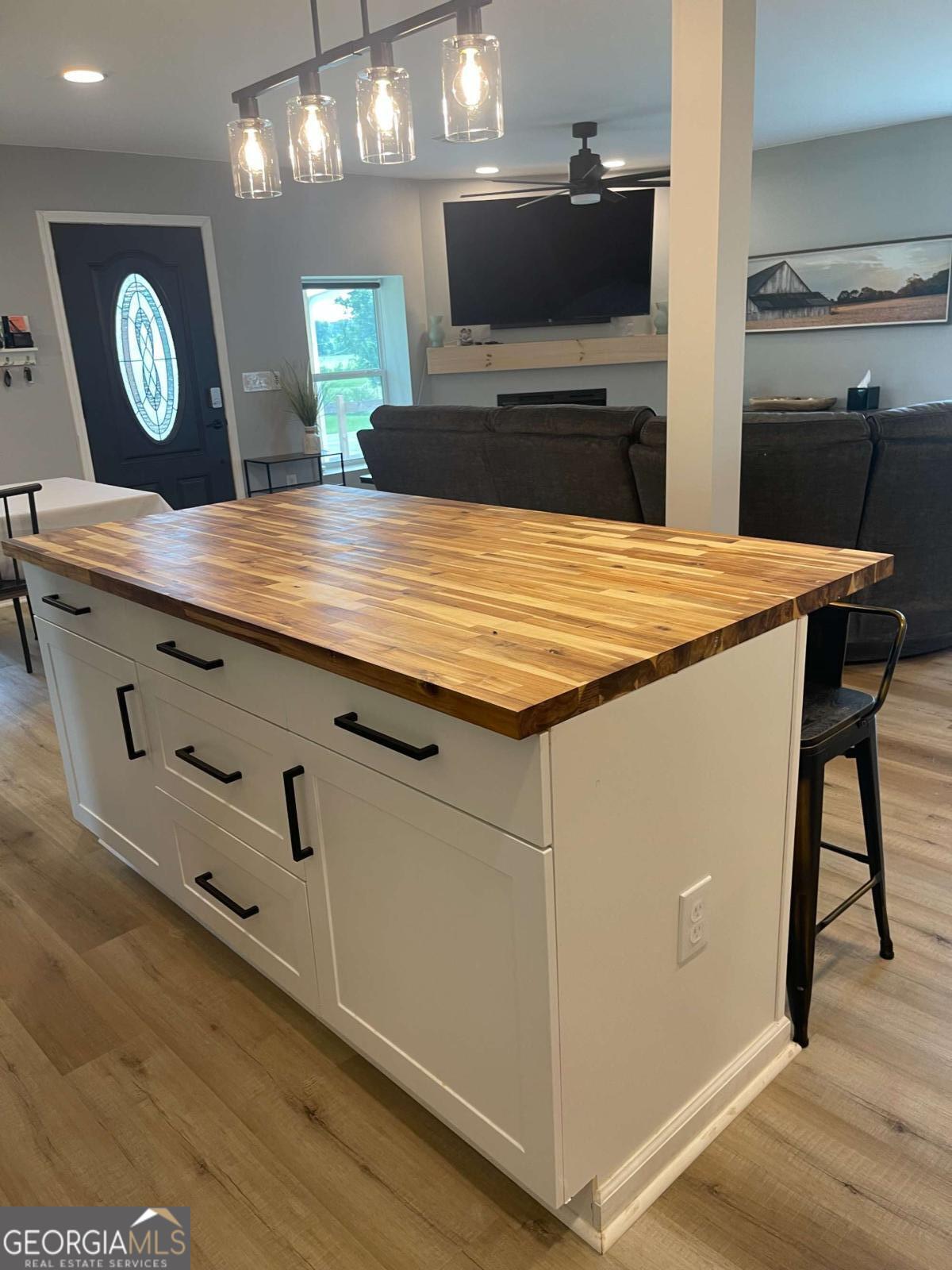433 Spring Place Resaca Road Chatsworth, GA 30705 - Photo 19 of 60 a kitchen with stainless steel appliances granite countertop a sink a stove and a wooden floors