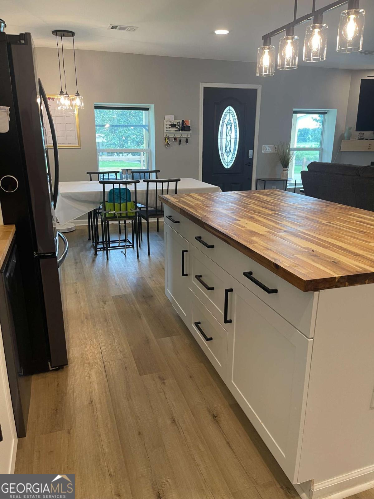 433 Spring Place Resaca Road Chatsworth, GA 30705 - Photo 20 of 60 a living room with furniture a large window and wooden floor