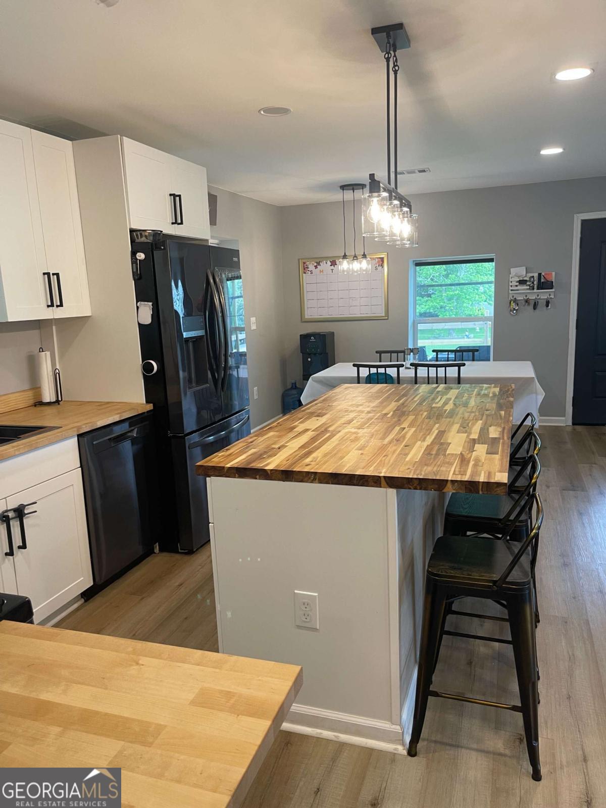 433 Spring Place Resaca Road Chatsworth, GA 30705 - Photo 22 of 60 a room with stainless steel appliances kitchen island granite countertop wooden cabinets