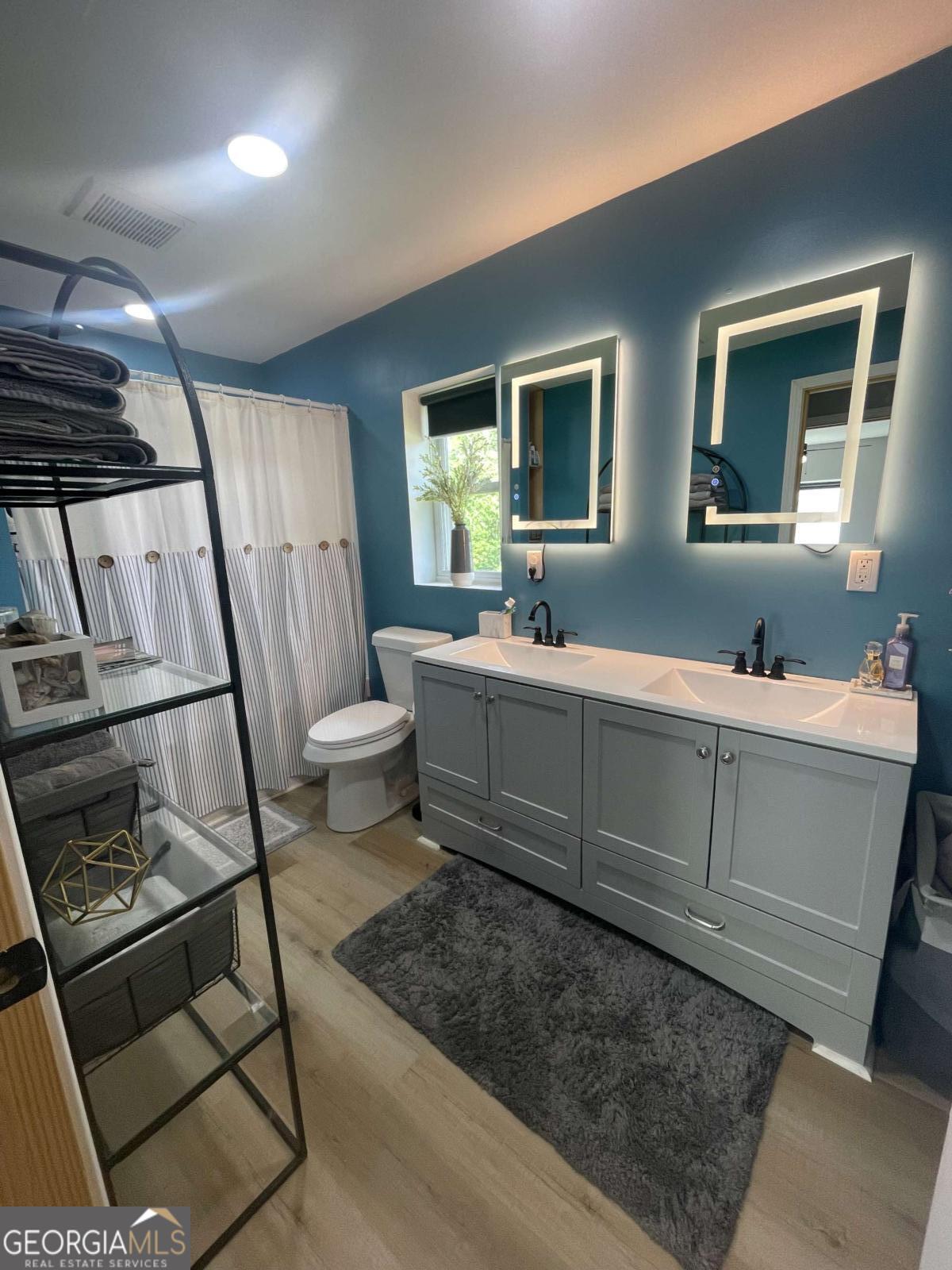 433 Spring Place Resaca Road Chatsworth, GA 30705 - Photo 39 of 60 a bathroom with 2 sink toilet and a mirror