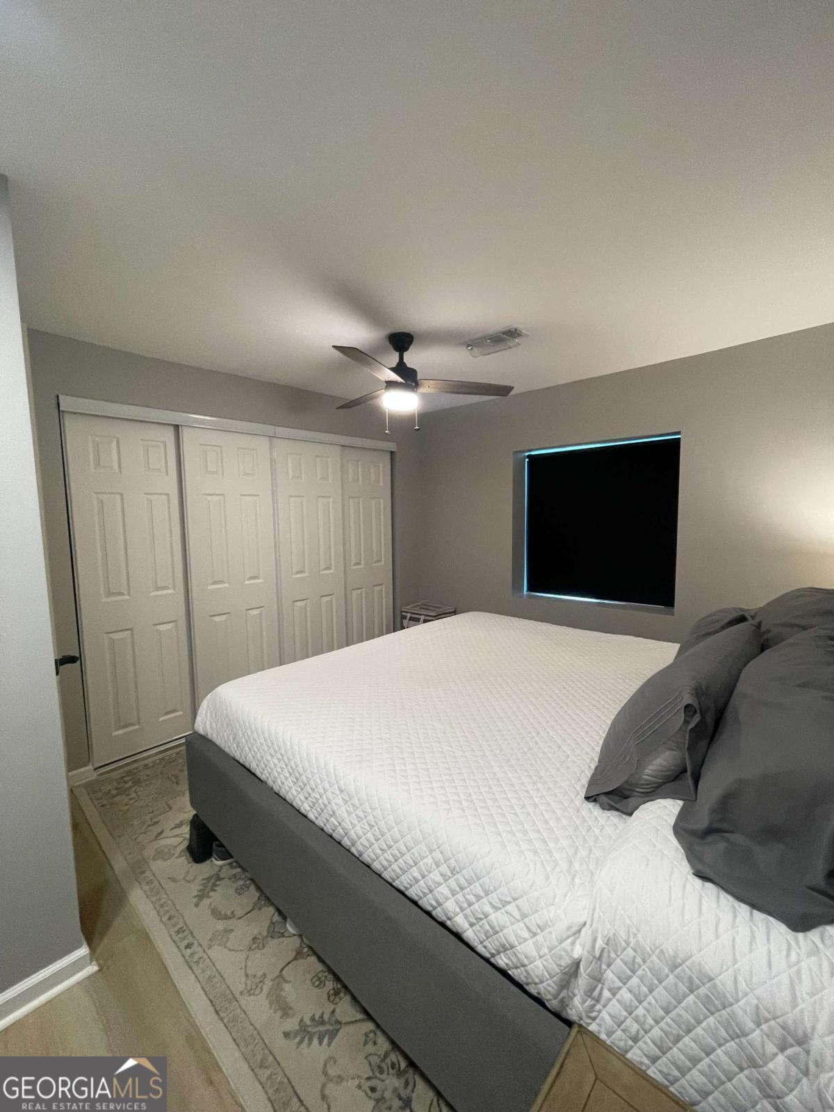 433 Spring Place Resaca Road Chatsworth, GA 30705 - Photo 41 of 60 a bedroom with a large bed and a chandelier