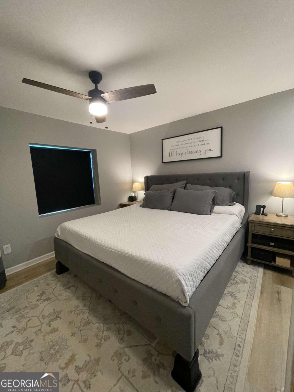 433 Spring Place Resaca Road Chatsworth, GA 30705 - Photo 42 of 60 a bedroom with a large bed a flat tv screen and chandelier