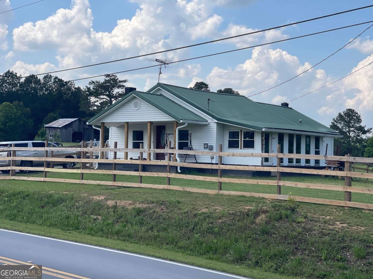 433 Spring Place Resaca Road Chatsworth, GA 30705 - Photo 9 of 60 a front view of a house with swimming pool having outdoor seating