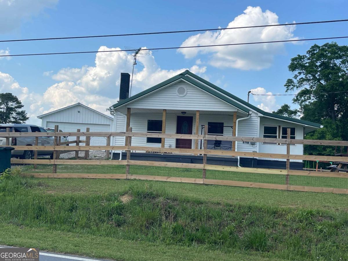 433 Spring Place Resaca Road Chatsworth, GA 30705 - Photo 10 of 60 a backyard of a house with table and chairs