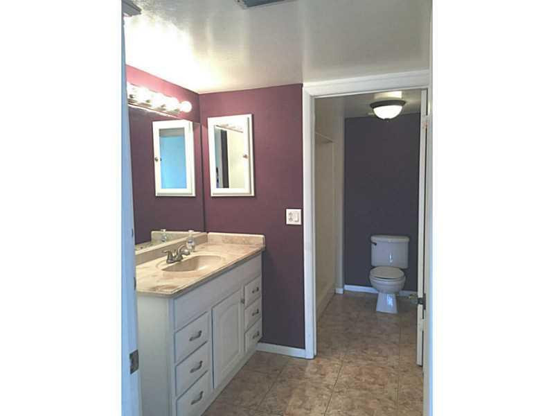 21955 Tidewater Terrace, Unit 208 Boca Raton, FL 33433 - Photo 13 of 26 a spacious bathroom with a granite countertop sink a toilet and a mirror
