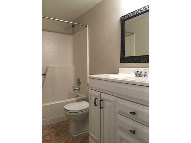 21955 Tidewater Terrace, Unit 208 Boca Raton, FL 33433 - Photo 20 of 26 a bathroom with a toilet a sink and a mirror