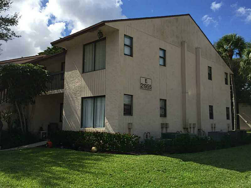 21955 Tidewater Terrace, Unit 208 Boca Raton, FL 33433 - Photo 2 of 26 a front view of house with yard and green space