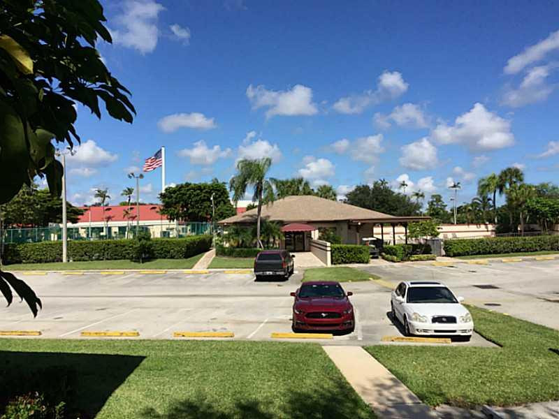21955 Tidewater Terrace, Unit 208 Boca Raton, FL 33433 - Photo 21 of 26 a view of a yard with cars parked