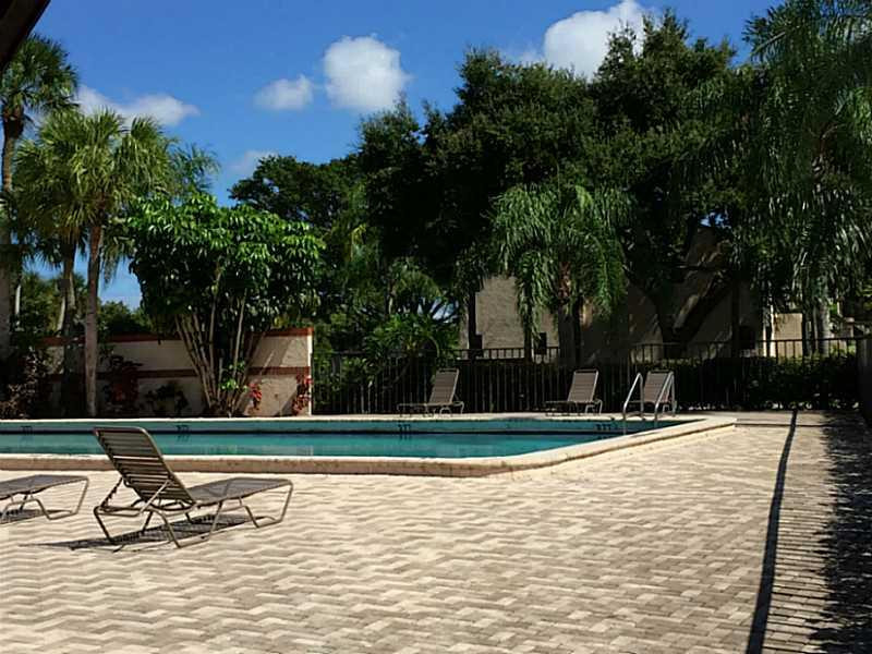 21955 Tidewater Terrace, Unit 208 Boca Raton, FL 33433 - Photo 23 of 26 a view of a swimming pool with a bench