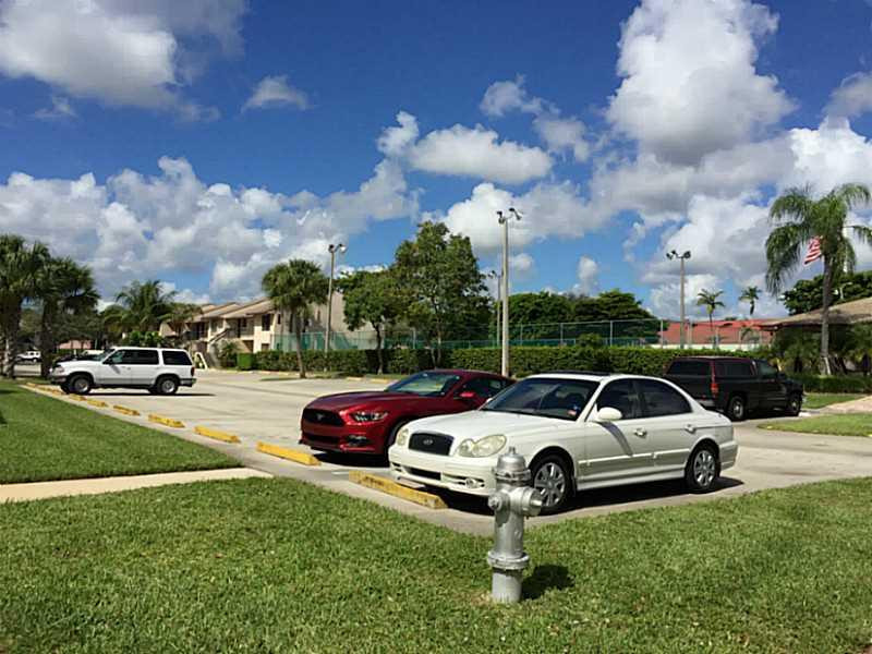 21955 Tidewater Terrace, Unit 208 Boca Raton, FL 33433 - Photo 25 of 26 a car parked in the side of the road