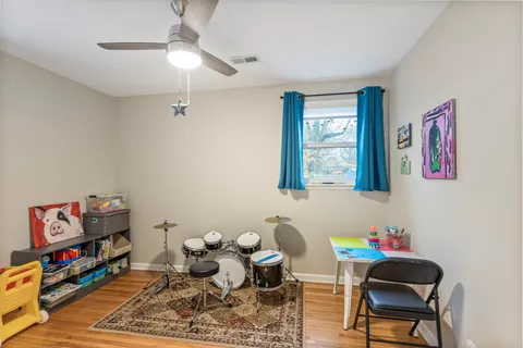 a living room with furniture and a bookshelf