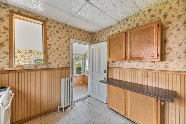 a view of a utility room with wooden walls