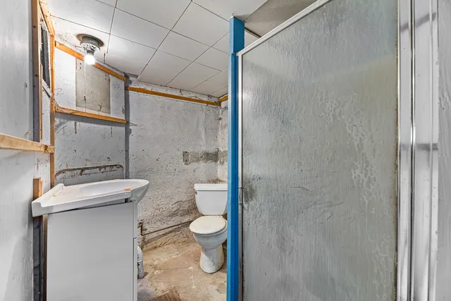 a bathroom with a granite countertop sink toilet and shower